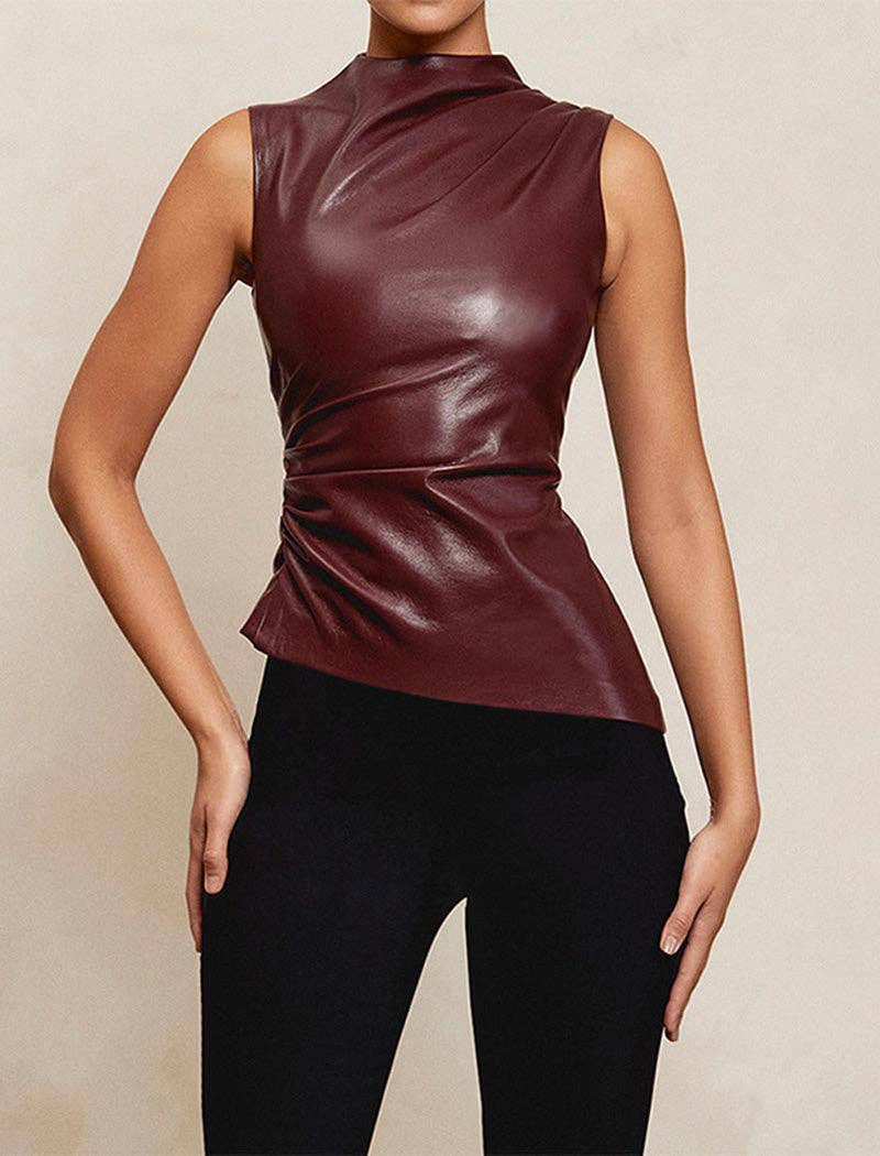 Person wearing a maroon sleeveless top and black pants on a beige background