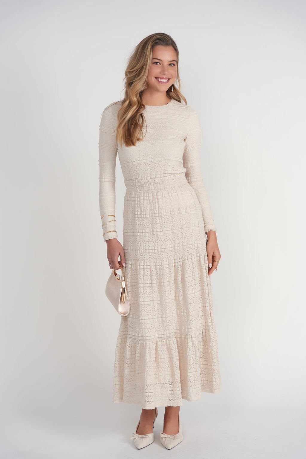Woman wearing a beige dress with a white background