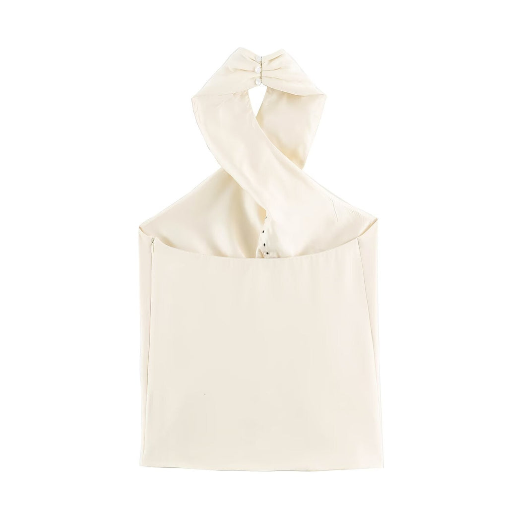 An off-white halter top with a large bow detail at the neck, displayed against a solid white background.