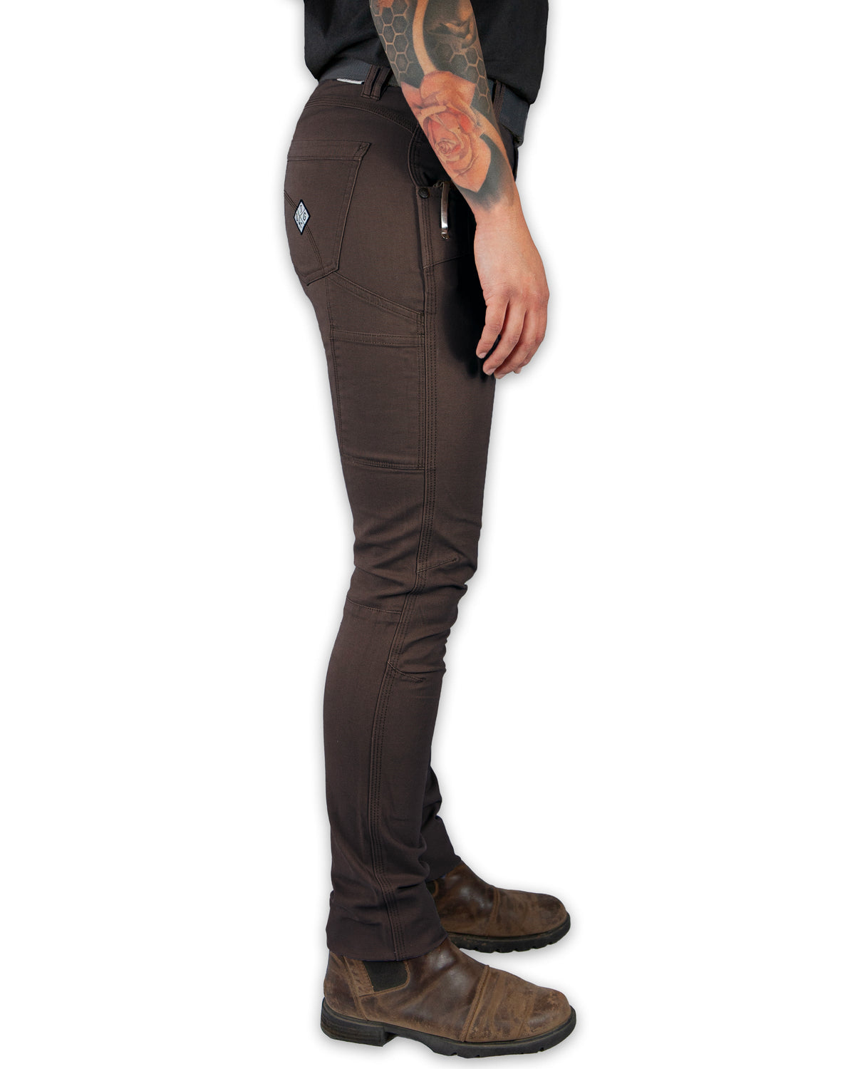 Brown pants worn by a person on a white background